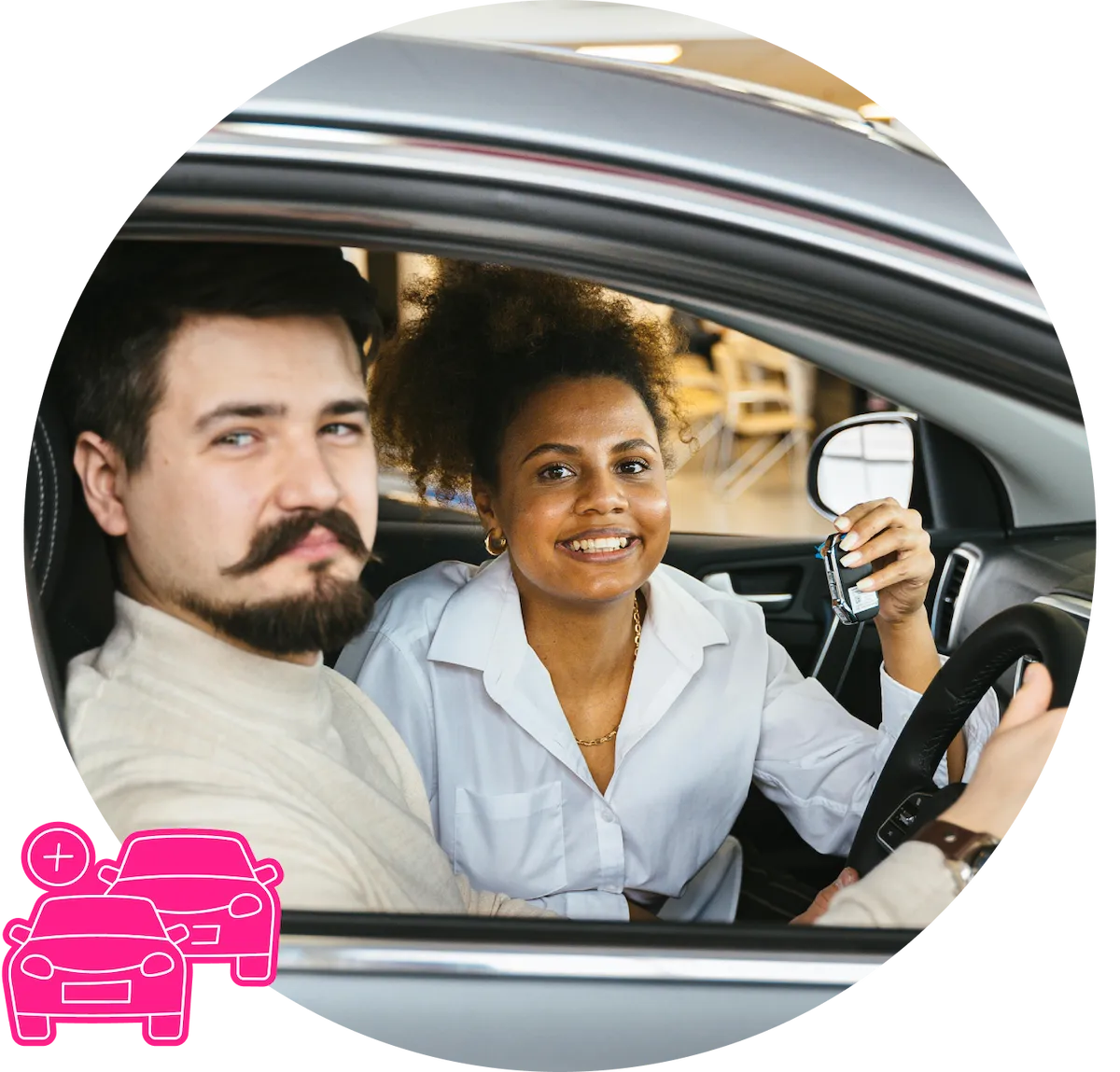 A couple smiling to camera, sitting in a car