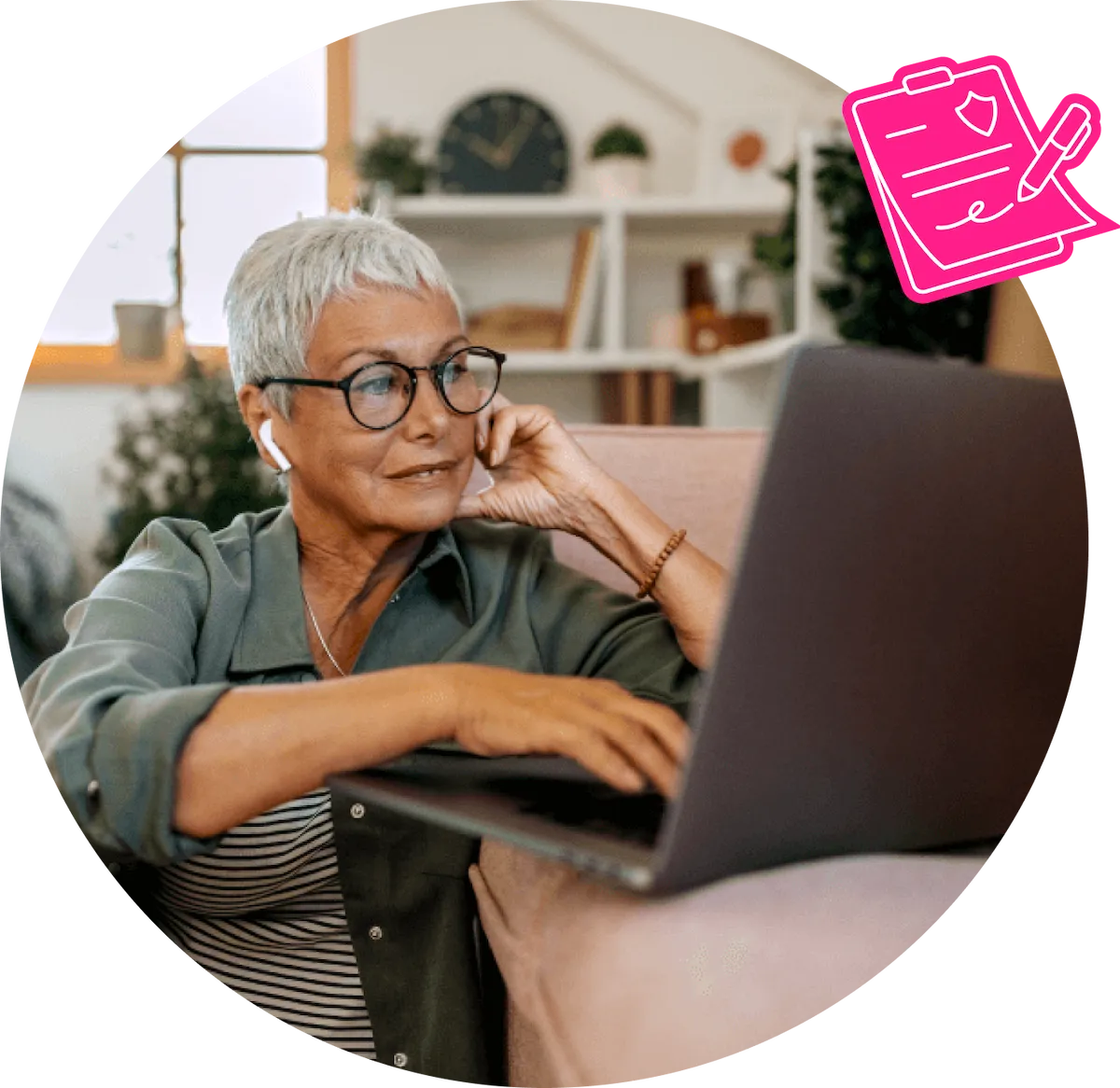 A grey haired older lady in glasses using her laptop